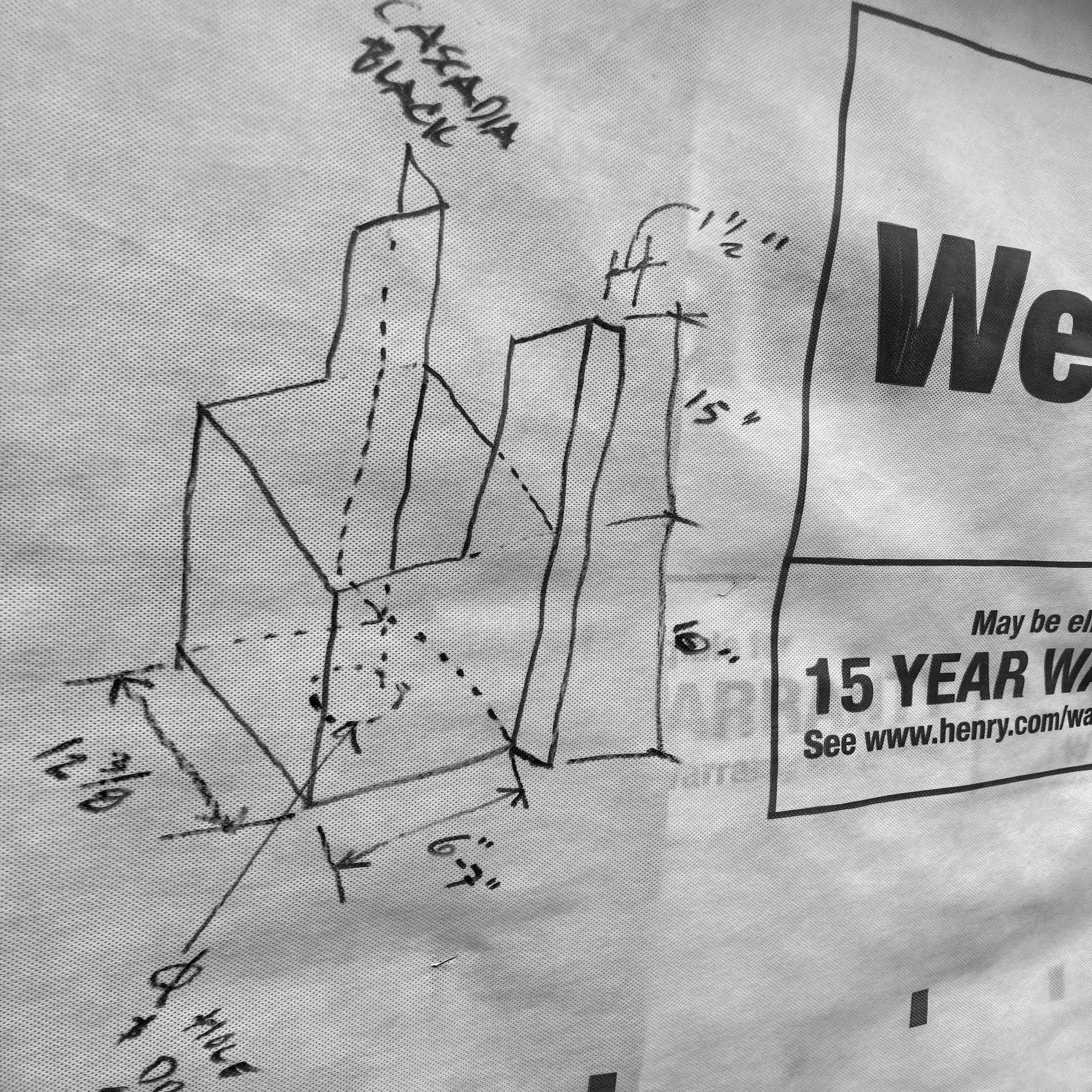 A hand-drawn 3D diagram of a geometric shape with annotations and measurements, including labels and dimensions.