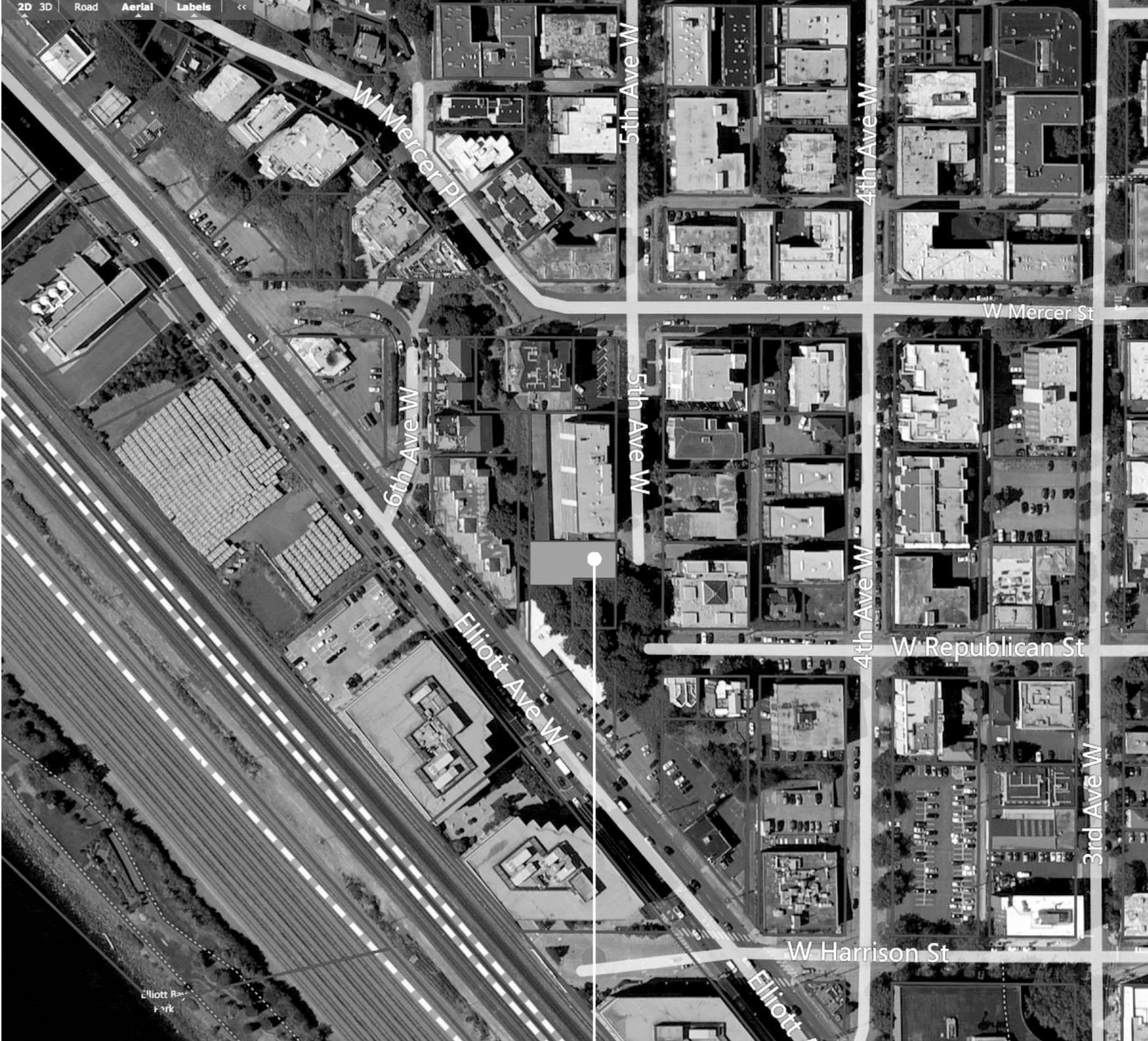 Aerial view of a city grid showing streets and buildings, with labeled streets including W Mercer Pl, 5th Ave W, 4th Ave W, W Republican St, W Harrison St, and Elliott Ave W, with a large highway running diagonally across the southwest corner.
