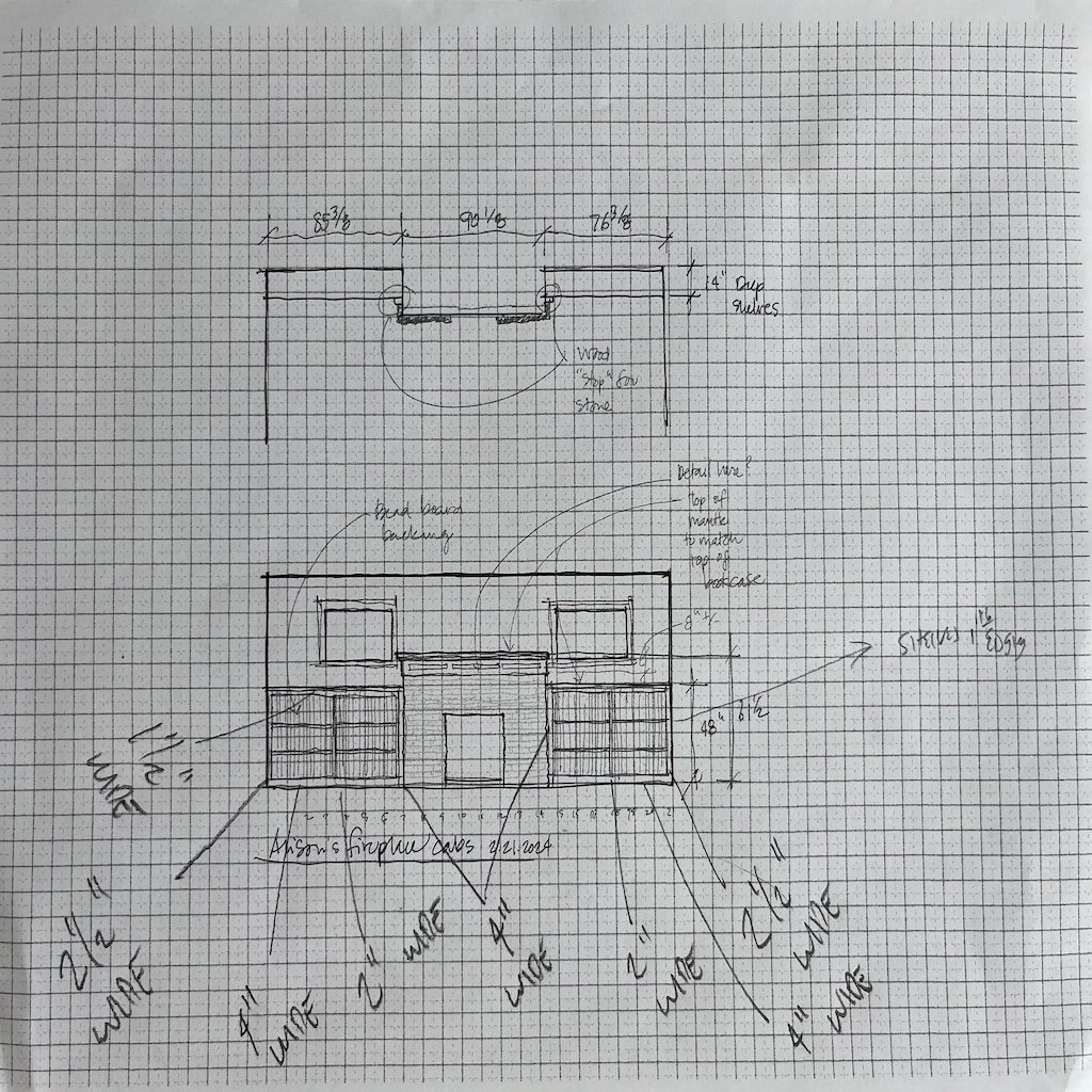Hand-drawn architectural sketch of a furniture or cabinetry design on graph paper, including measurements, notes, and labeled features such as shelves, doors, and structural details.