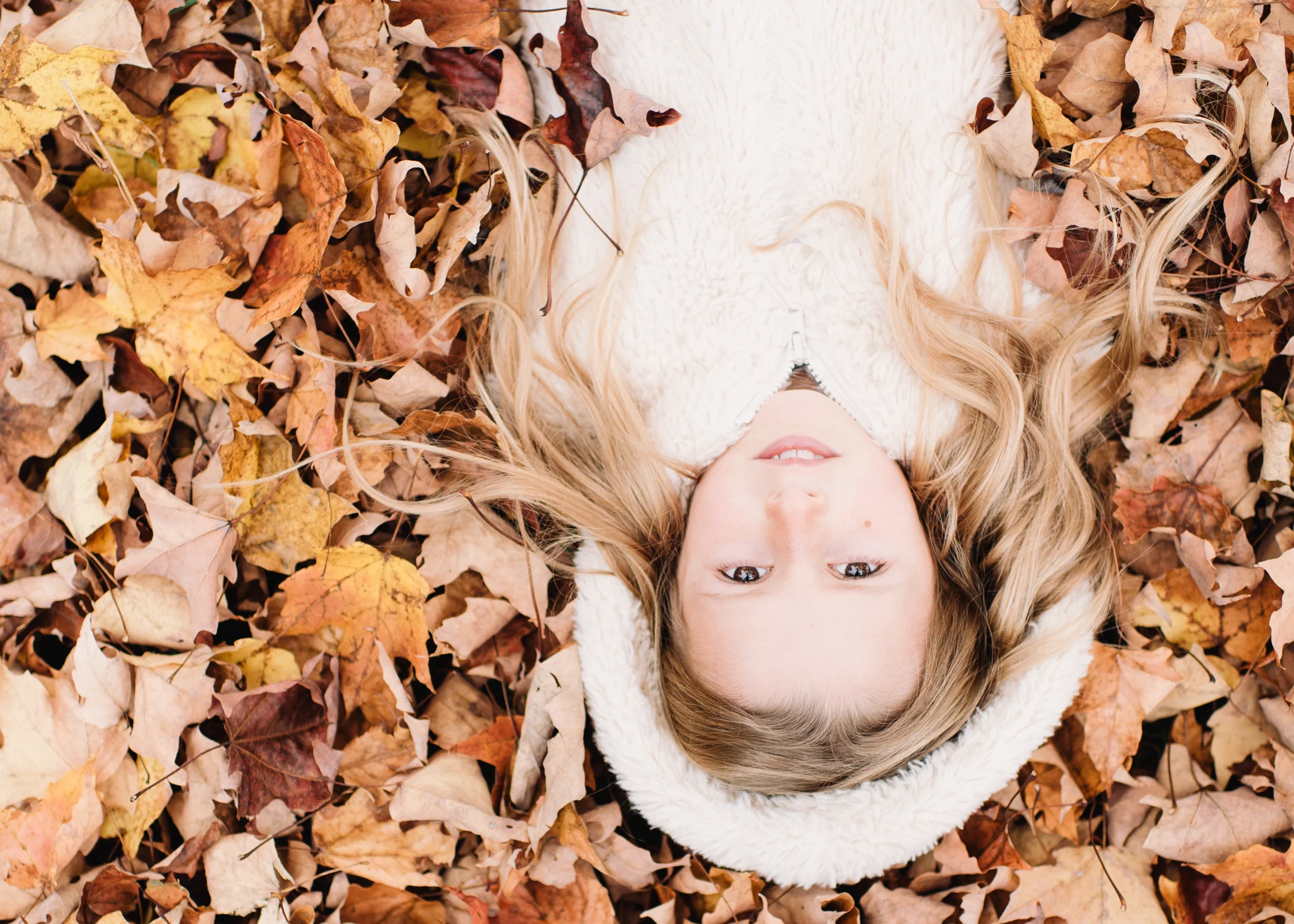 girl in autumn leaves - maine children's portrait photographer