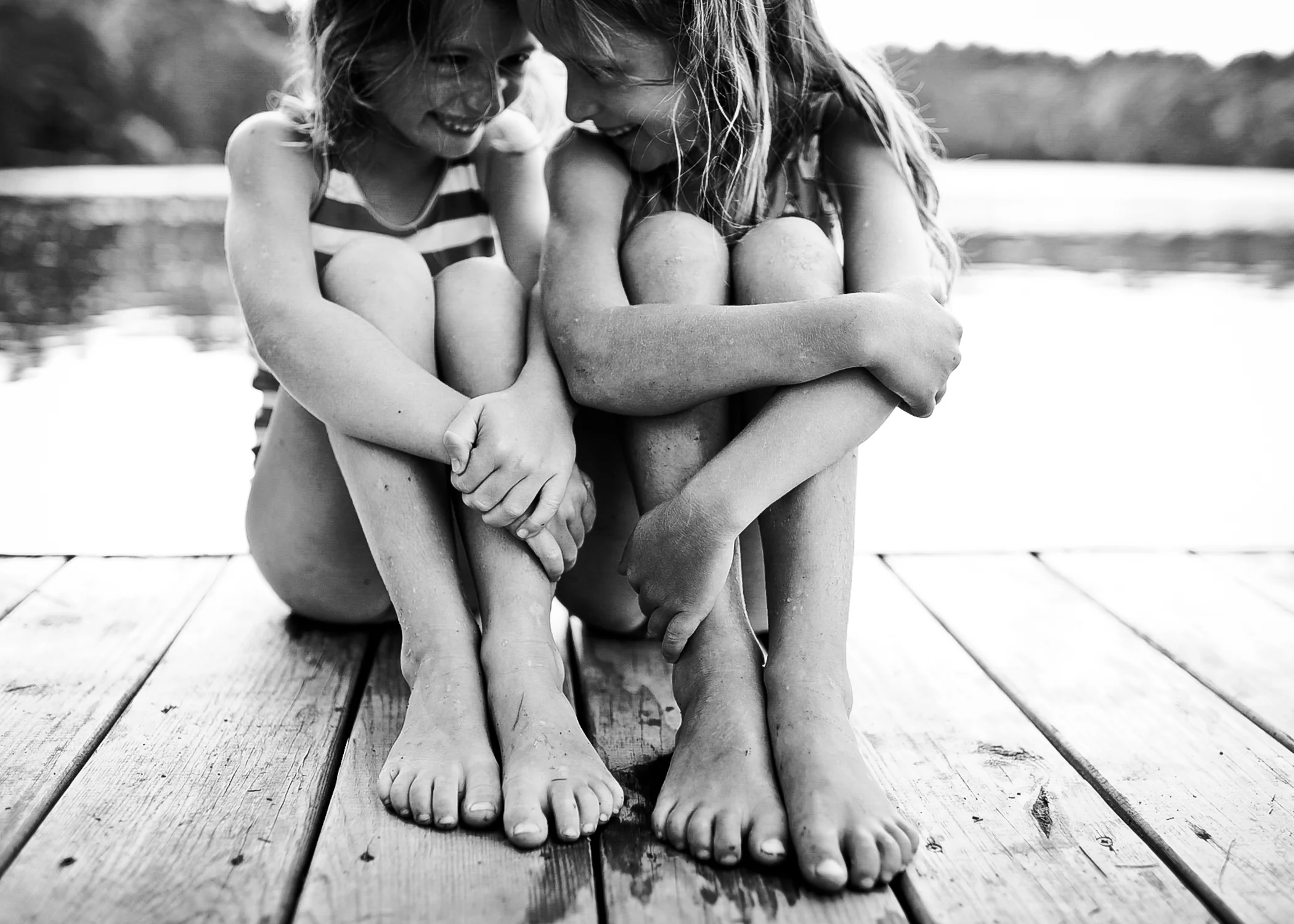 girls on dock laughing - maine timeless children's portraits
