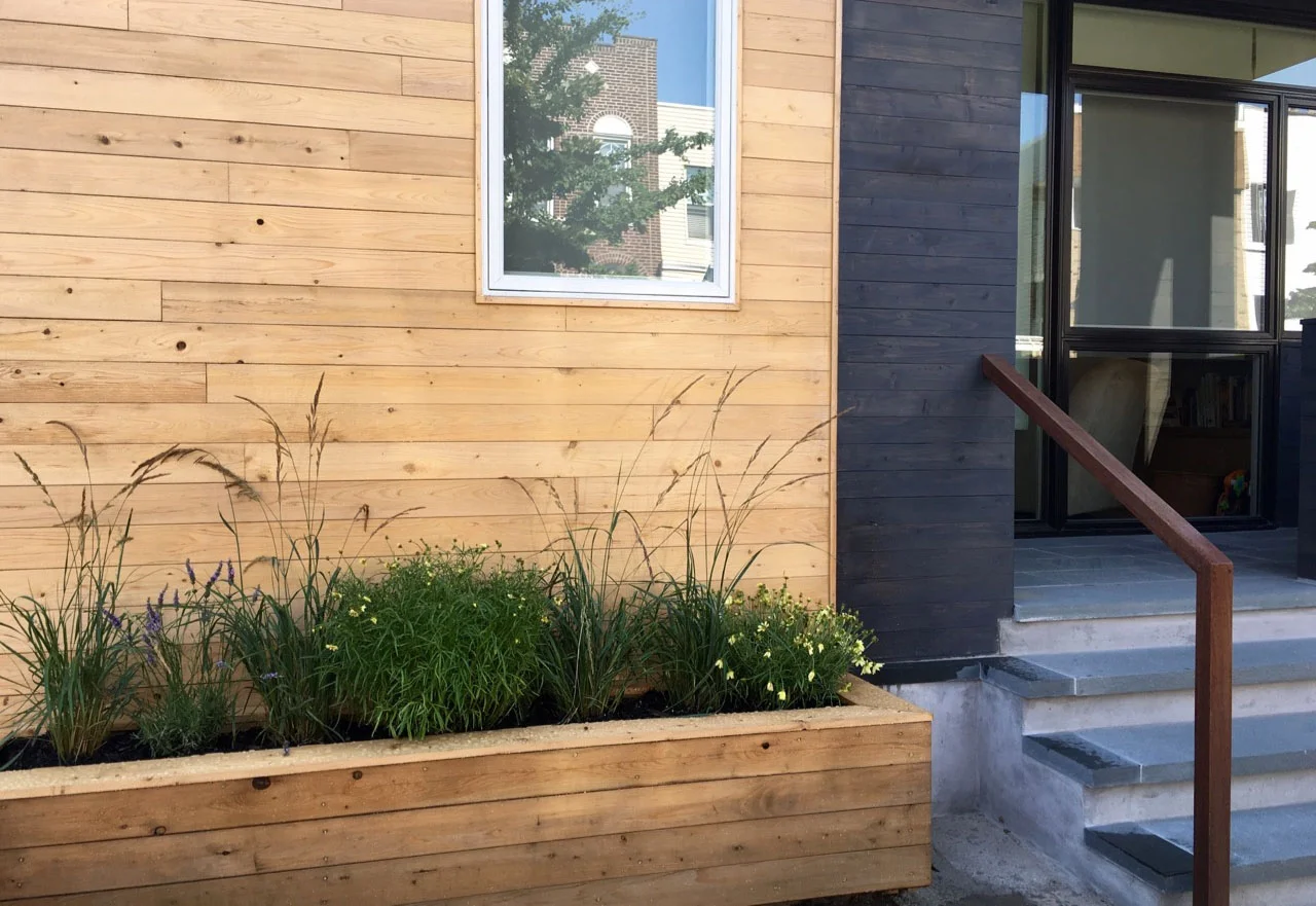Freshly planted planters directly in front of the house