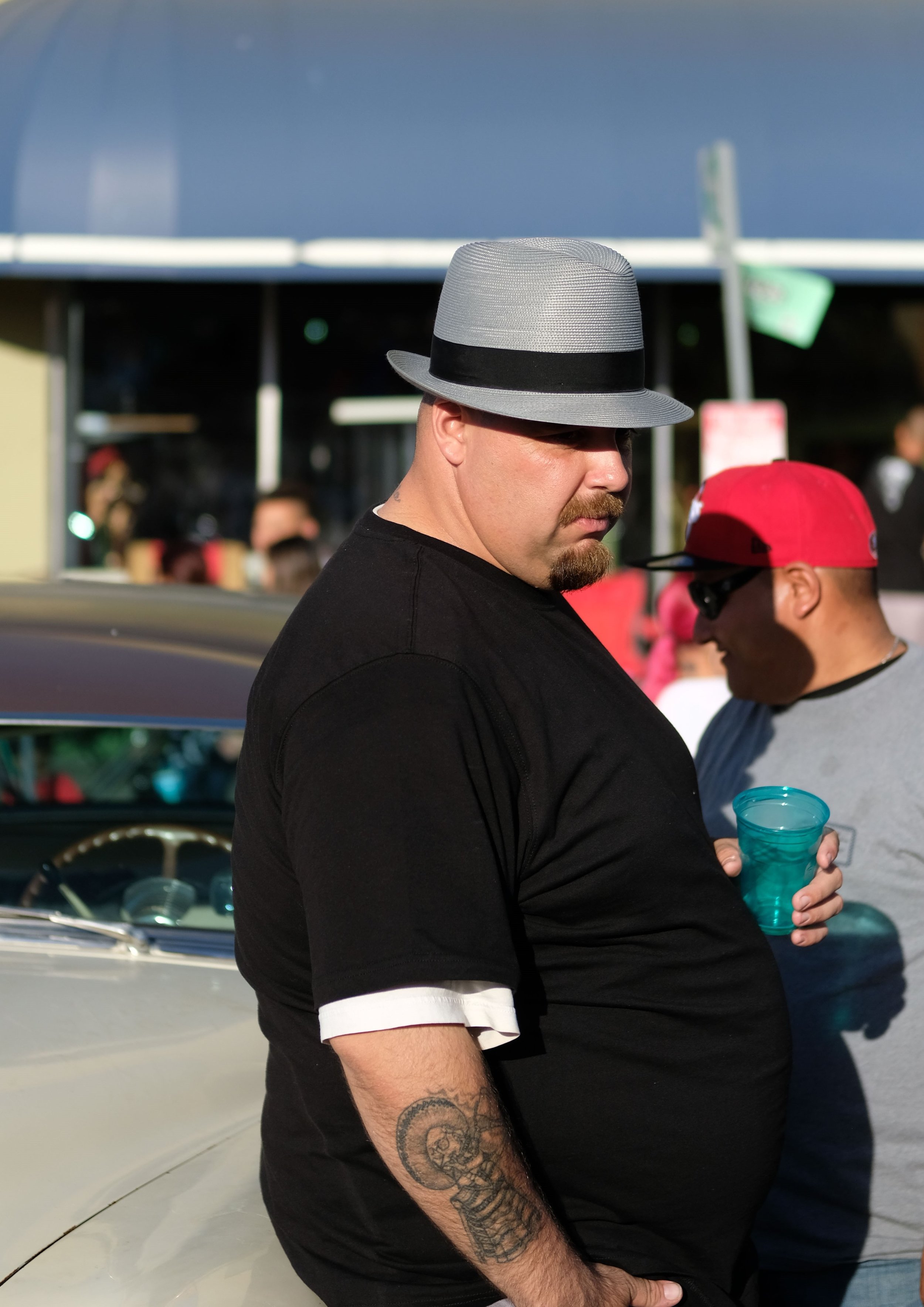  Two men admire custom lowriders during the Dia de los Muertos festival. Oakland, CA. 