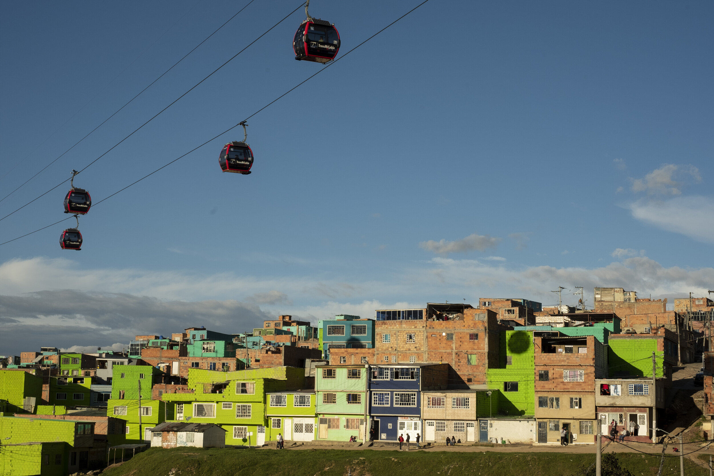  The TransMiCable aerial gondola system passes over the multicolored homes of Juan Pablo II, one of the neighborhoods of Ciudad Bolivar served by the transit system since 2018. 