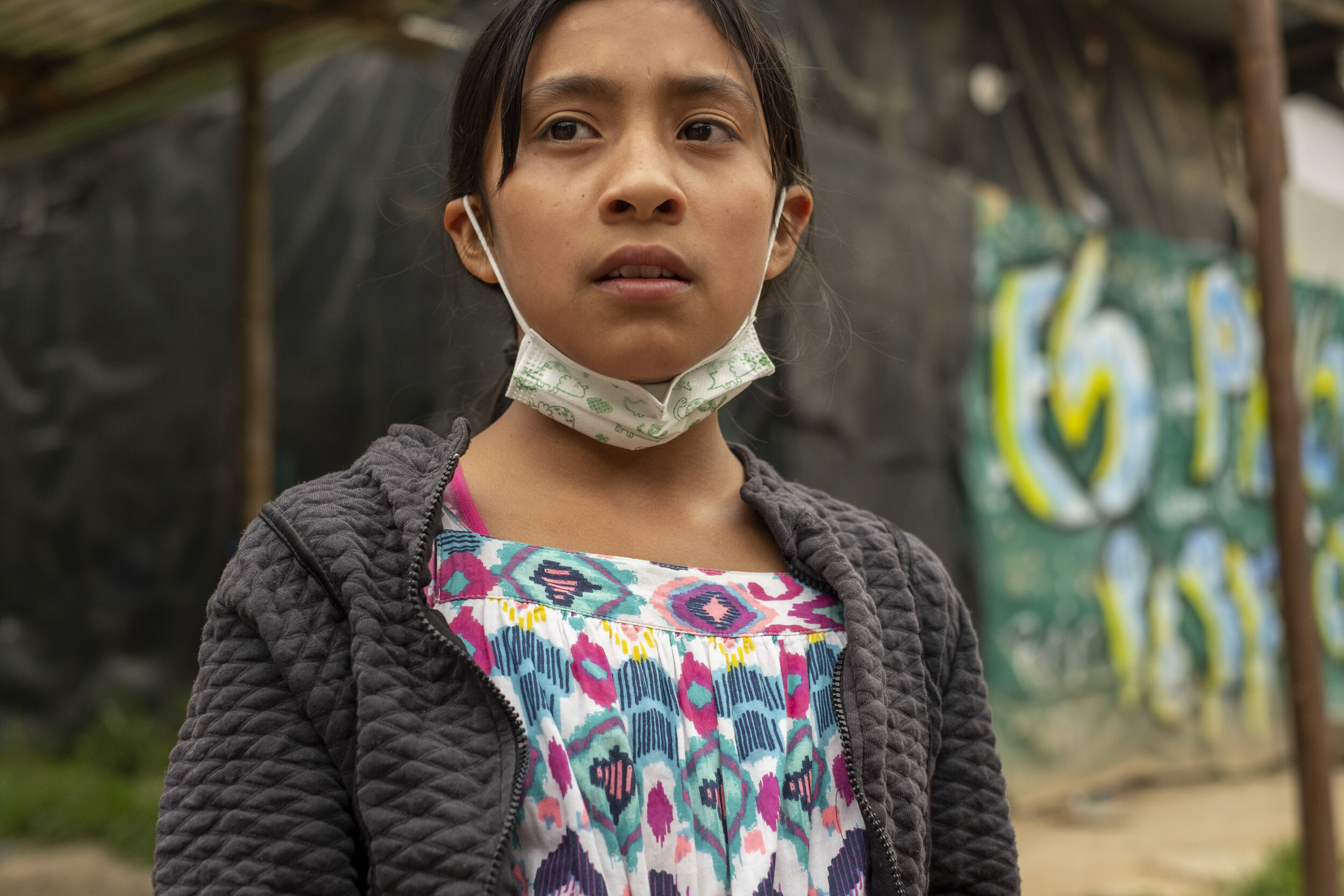  A young girl waits outside of a youth support foundation in Ciudad Bolivar, Bogotá.  