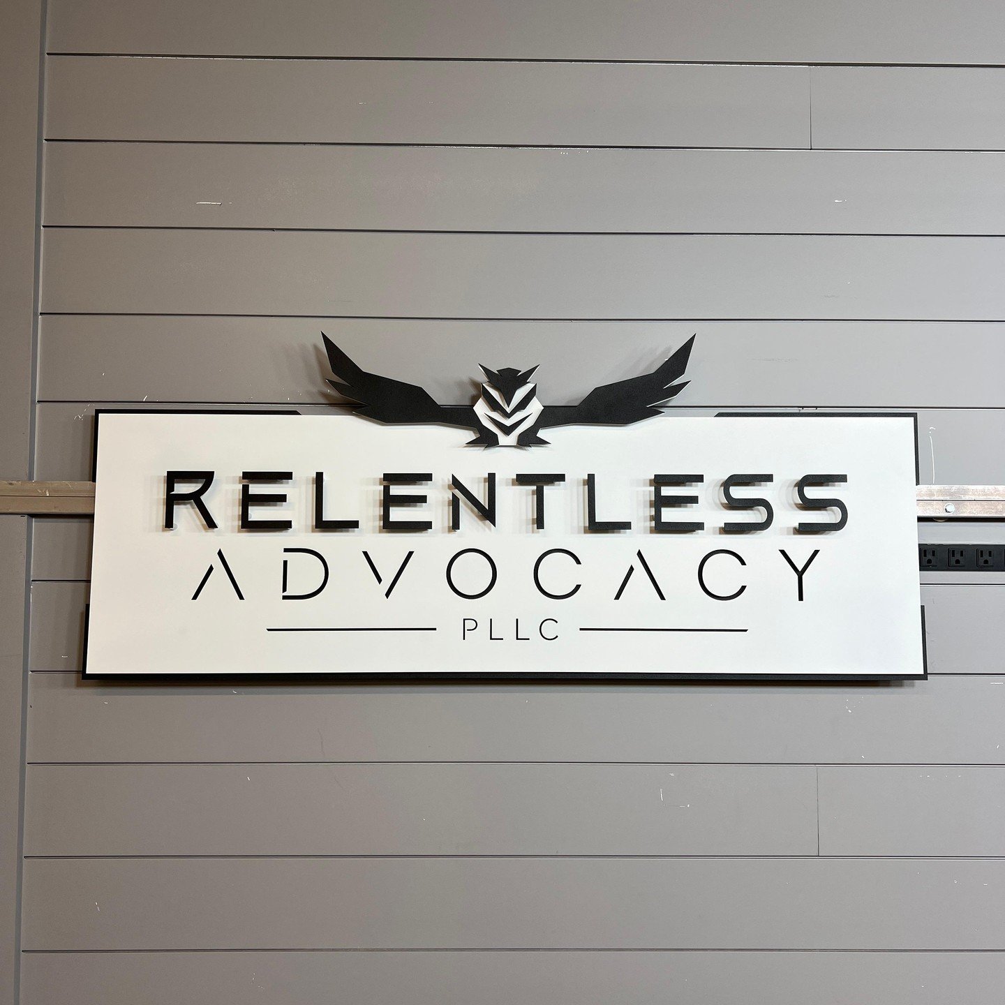 Today we're showcasing a sign we created recently for Relentless Advocacy PLLC in Brentwood, Tennessee.  The featured sign is one example of our modern black on white look. This sign is a perfect example of how we can turn your logo into art!

Lookin