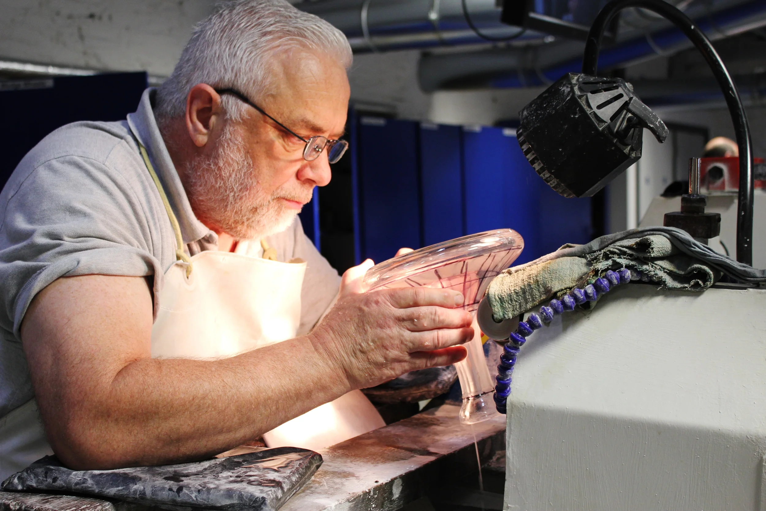  At the Waterford Crystal factory in Waterford, Ireland, a craftsman carefully cuts into the crystal. 