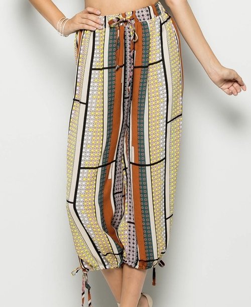 Print Midi Pants look cool and chic when worn with this black lightweight hi/low hem blouse ,a rust arrowhead necklace ,and some gladiators for a special night out with friends.
