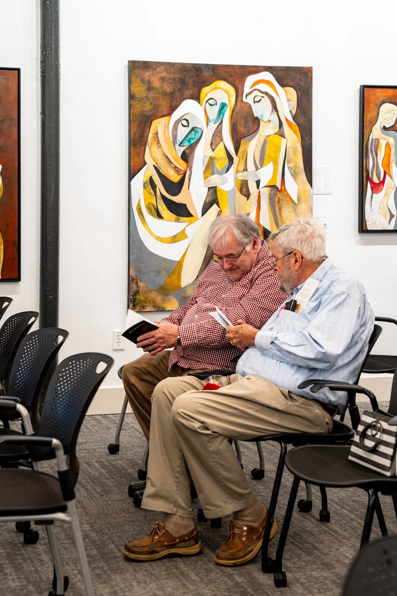 2 cute old guys looking at Gaudi sketchbooks.JPG
