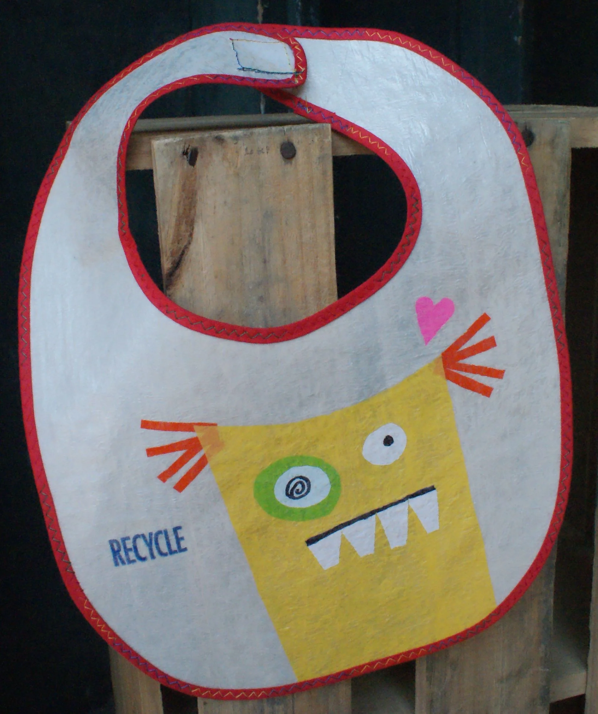 This bib is AWESOME! It is made from 7 layers of fused plastic grocery bags and is hand washable. No need to wait for the washing machine to get your bibs clean. Just run it under the faucet, and it is clean and ready to go.