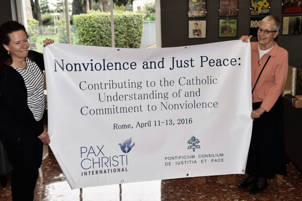 Judy Coode and Marie Dennis share the banner for the Nonviolence and Just Peace conference (Gerry Lee)