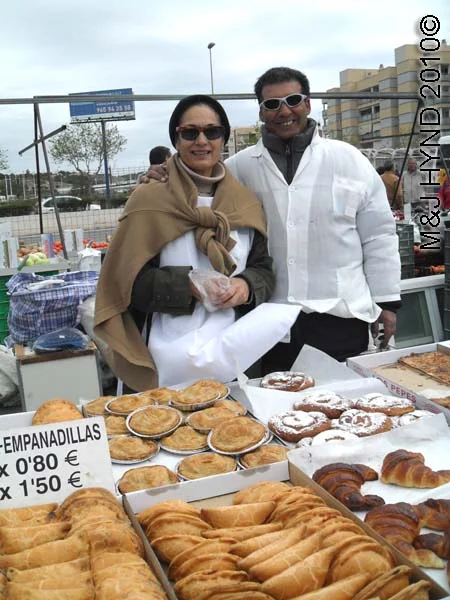santa pola market pastry vendors: spain santa Pola Saturday market, pastry, empanadilla, ensaimada, filled sweet buns, thin pastry filled with membrillo (quince)