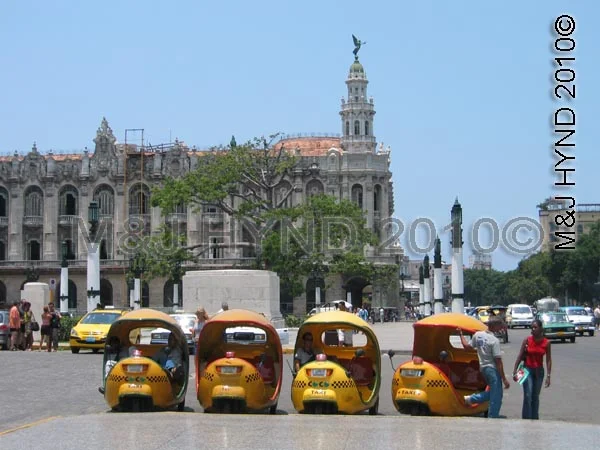 havana: coco-taxis, egg-shaped, three-wheeler in the shape of a yellow coconut, downtown Havana city, cuba, worldwide holiday ideas