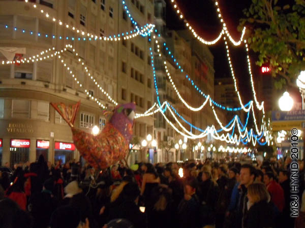 sardine #2: spain Alicante Carnival Fiesta, Costa Blanca, doomed sardine carried through darkened streets by throng of people, festive lights