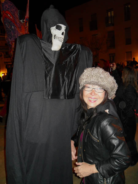 Jacq with grim reaper: spain Alicante Carnival Fiesta, Costa Blanca, darkened street, dressed in black, meet Grim Reaper
