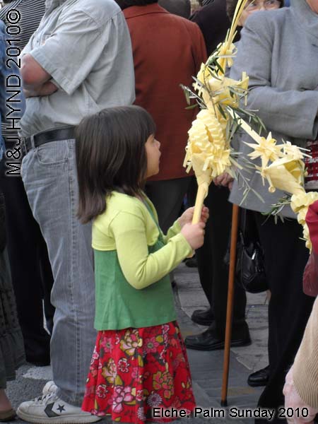  spain elche, Semana Santa Holy Week, Domingo de Ramos, Palm Sunday Procession Fiesta of International Tourist Interest, Brotherhood flag-bearers long capes, white-palms, somber march, Palm park 