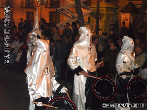  spain elche, Brotherhood long pointed white hood, long capes, procession, marching drummer bands, near Townhall, crowded street parade, 