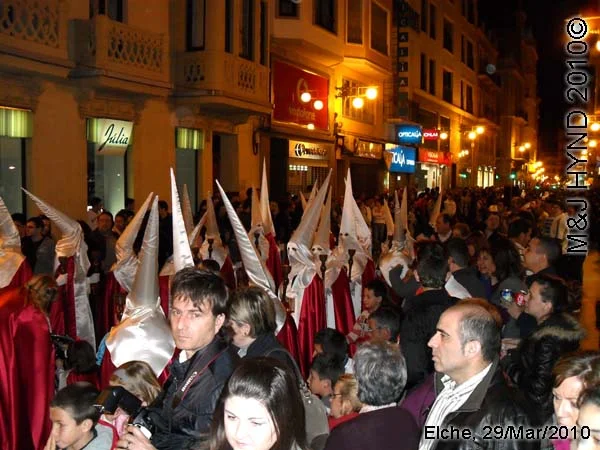 spain elche, Brotherhood long pointed white hood, long capes, procession, near Townhall, crowded street parade