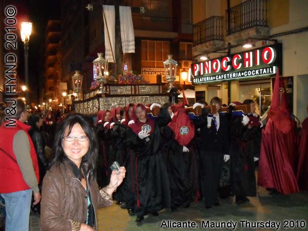  spain Alicante, Semana Santa Holy Week, Maundy Thursday procession, Brotherhood long pointed red hood, long capes, paso-bearers religious floats, silver Jesus's sculpture, somber march 