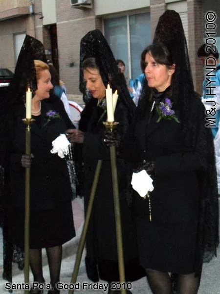spain Santa Pola, Semana Santa Holy Week, Good Friday procession, black lace-mantilla dressed ladies carry candle on poles