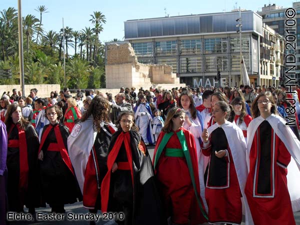 spain elche, Holy Week, Hallelujah Procession of the Brotherhood Easter Sunday, many-coloured long robes capes, Palacio de Altamira, M.A.H.E., crowded street parade,