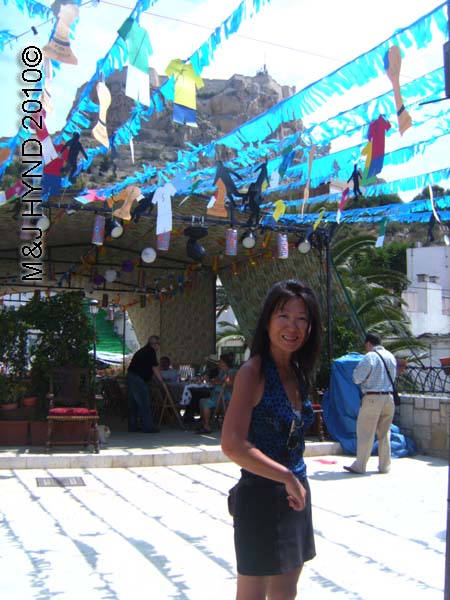 Jacq with blue bunting: spain, Alicante Santa Cruz Fiesta, Castillo Fortaleza de Santa Barbara, open-air square, festive buntings