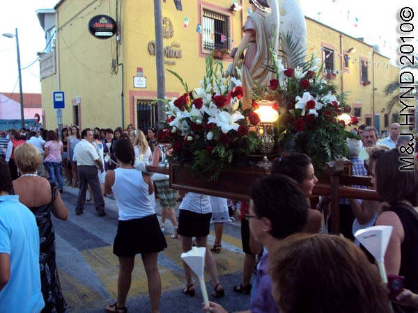 paseo / saint on the plinth:; spain valverde fiesta La Virgen de Santa Ana, flags buntings, candle-lit procession, paso-bearers, religious floats, image sculpture of Santa Ana