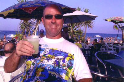Spain Carabassi beach, having a frozen margarita at chiringuito beachbar under palapa sunbrella