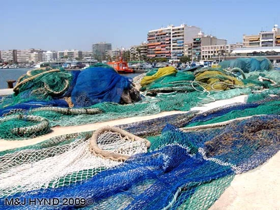 pain Santa Pola Fishermens' tools of the trade, multi coloured nets in port area, town