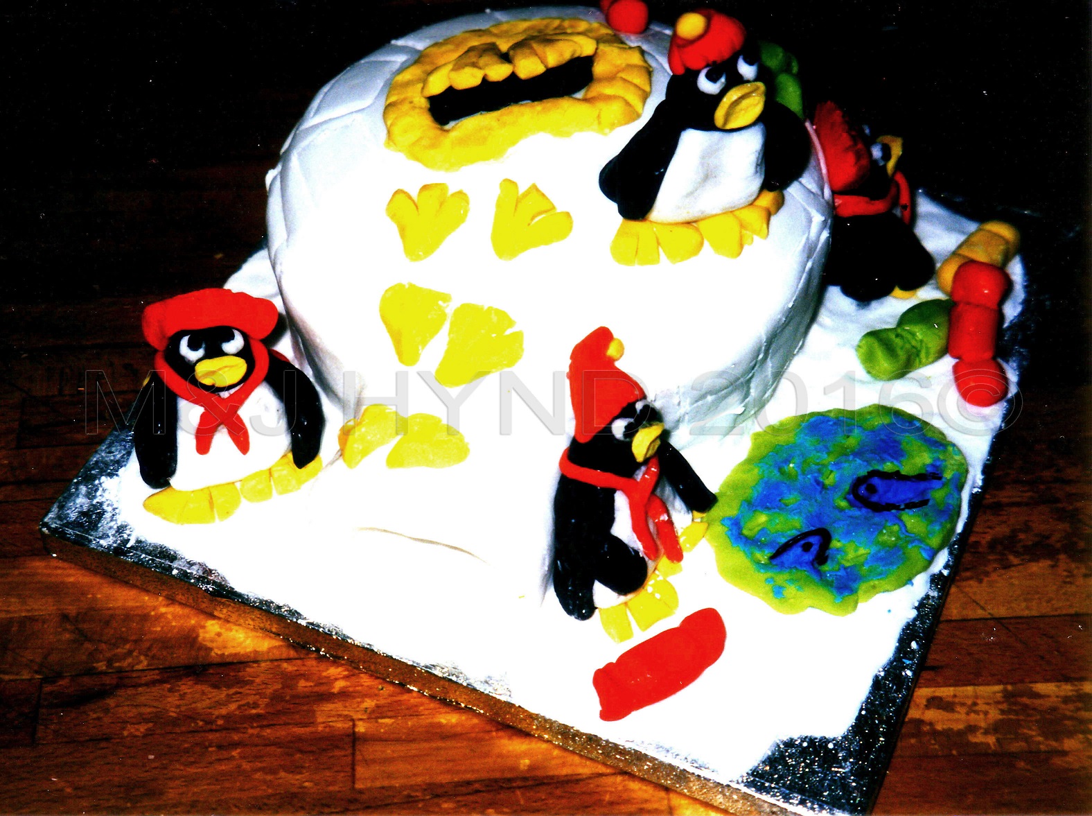 one-handed penguin Christmas cake, London, UK