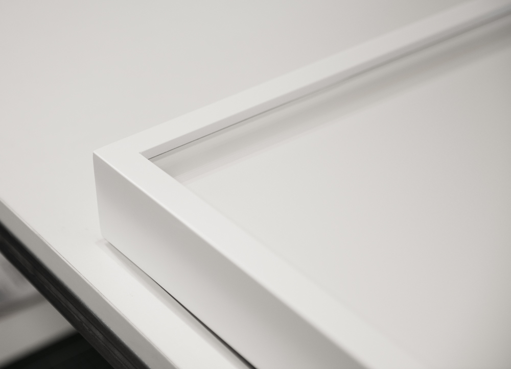 Detail of smooth lacquer finish used on the frames throughout the exhibition