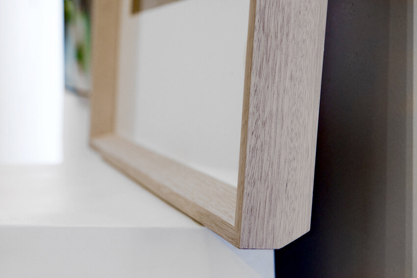 Geometric contemporary frame with set back glass. Both inner and outer bevel in a bleached frame.