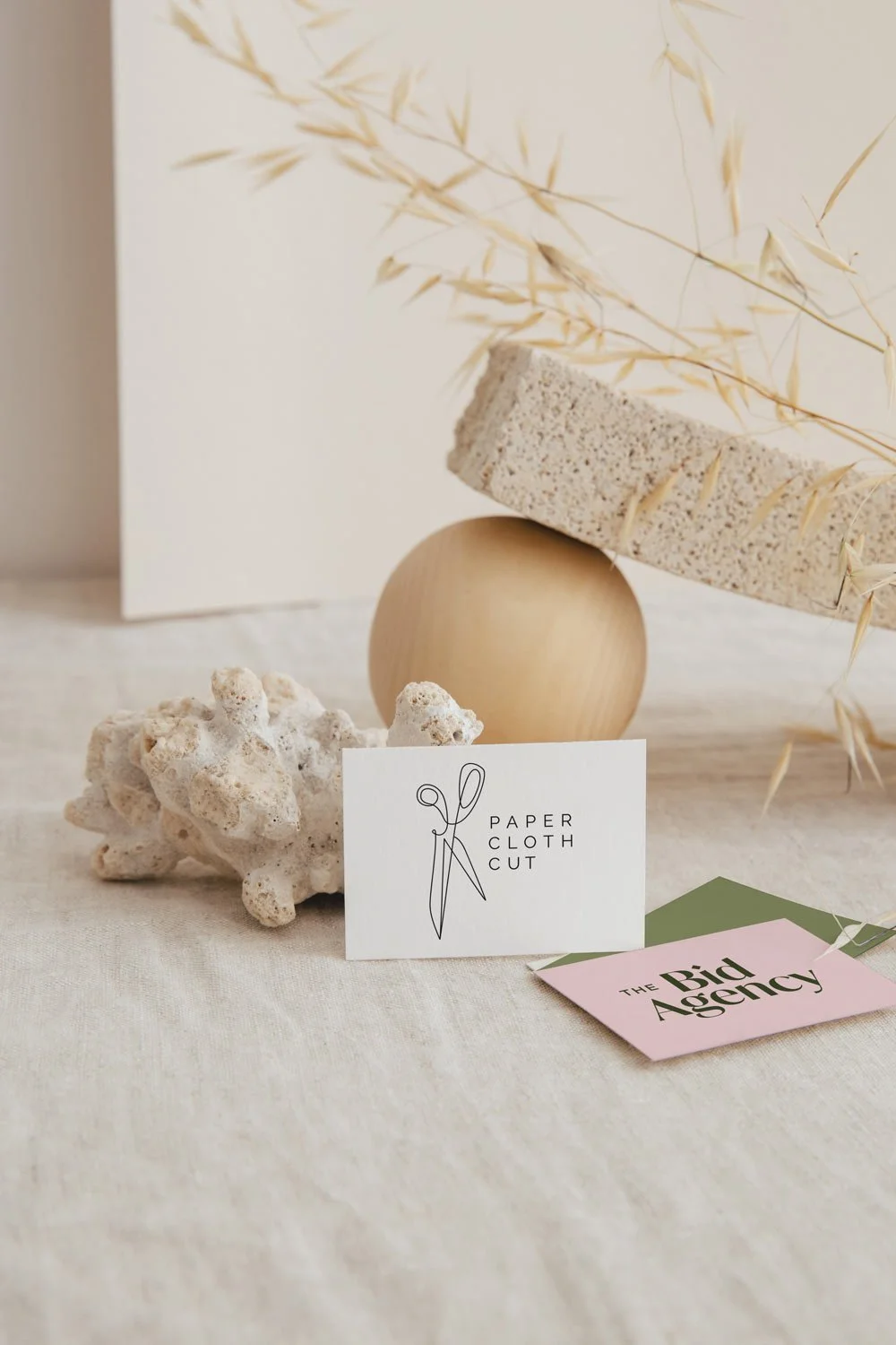 Branded business cards with logos by Perth branding & logo designer - Joanne Tapodi Creative, shown in an minimal aesthetic setting.