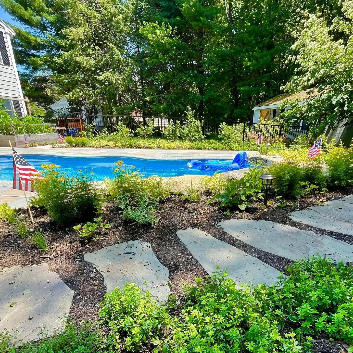 Check out this backyard transformation we completed just in time for summer! We designed and installed a beautiful #bluestone patio around this in-ground pool. Surrounding the pool are a robust mix of #flowers, #edibleplants, #herbs, and #fruittrees.