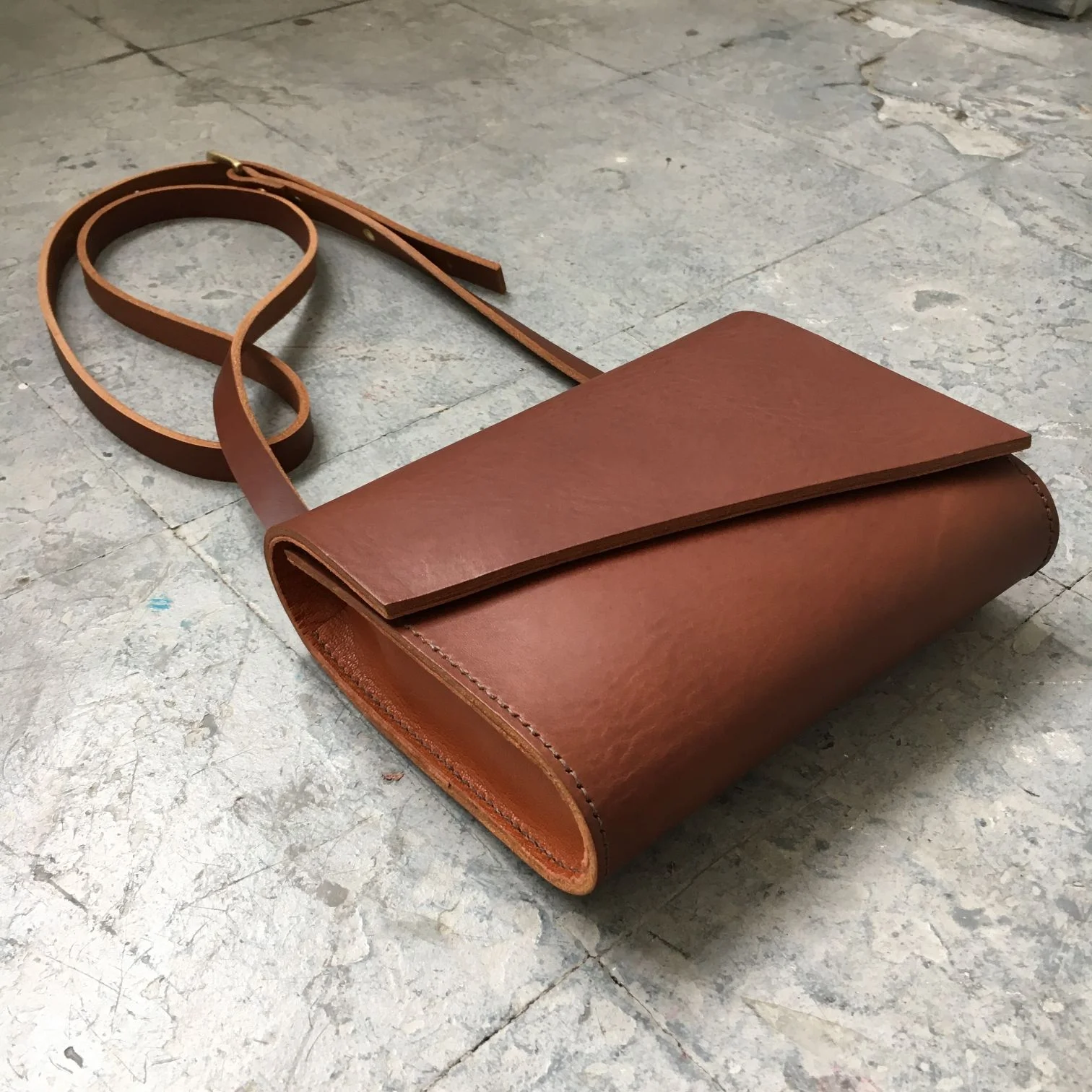 Side of Brown leather crossbody bag by CARV made in London