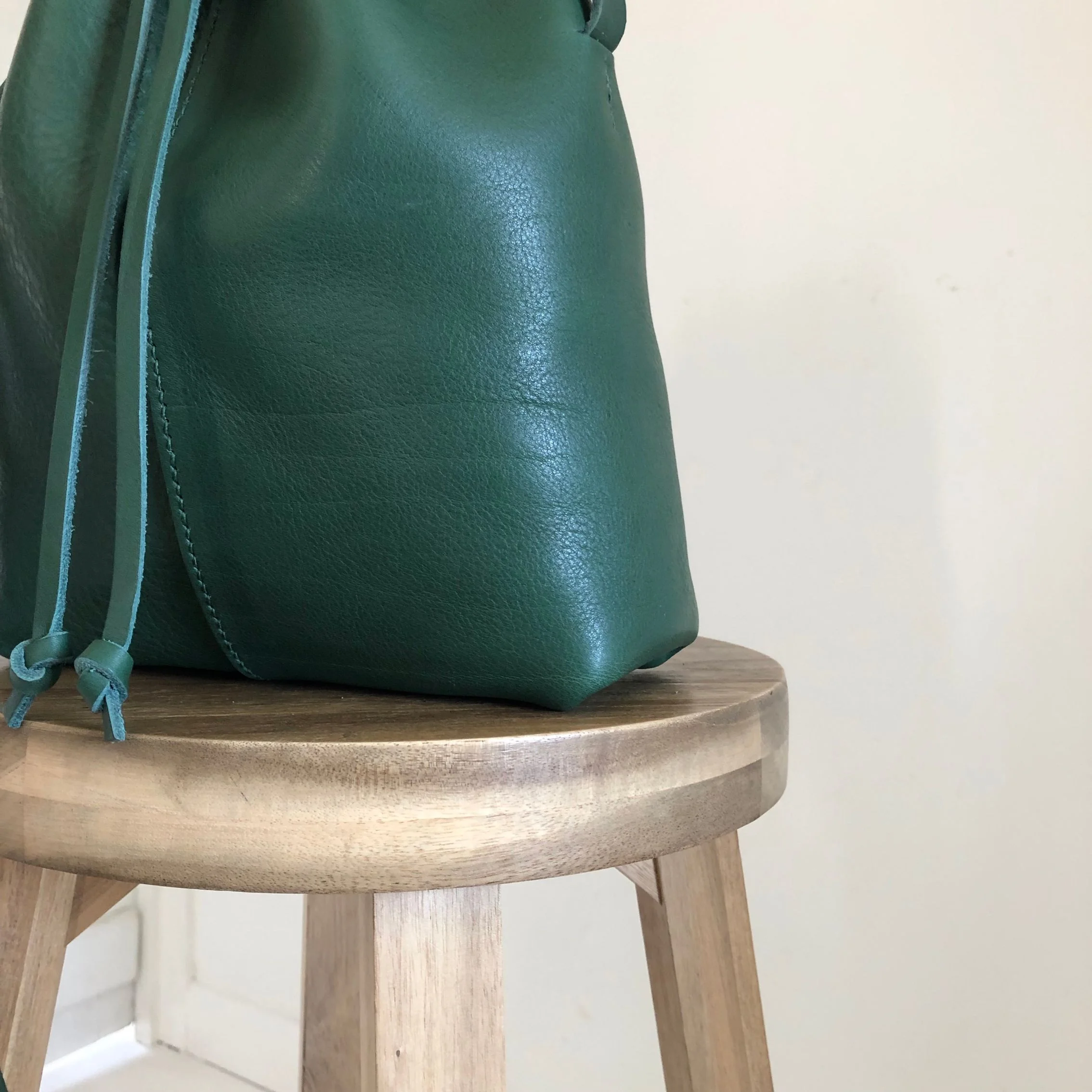 Green leather bucket bag by CARV