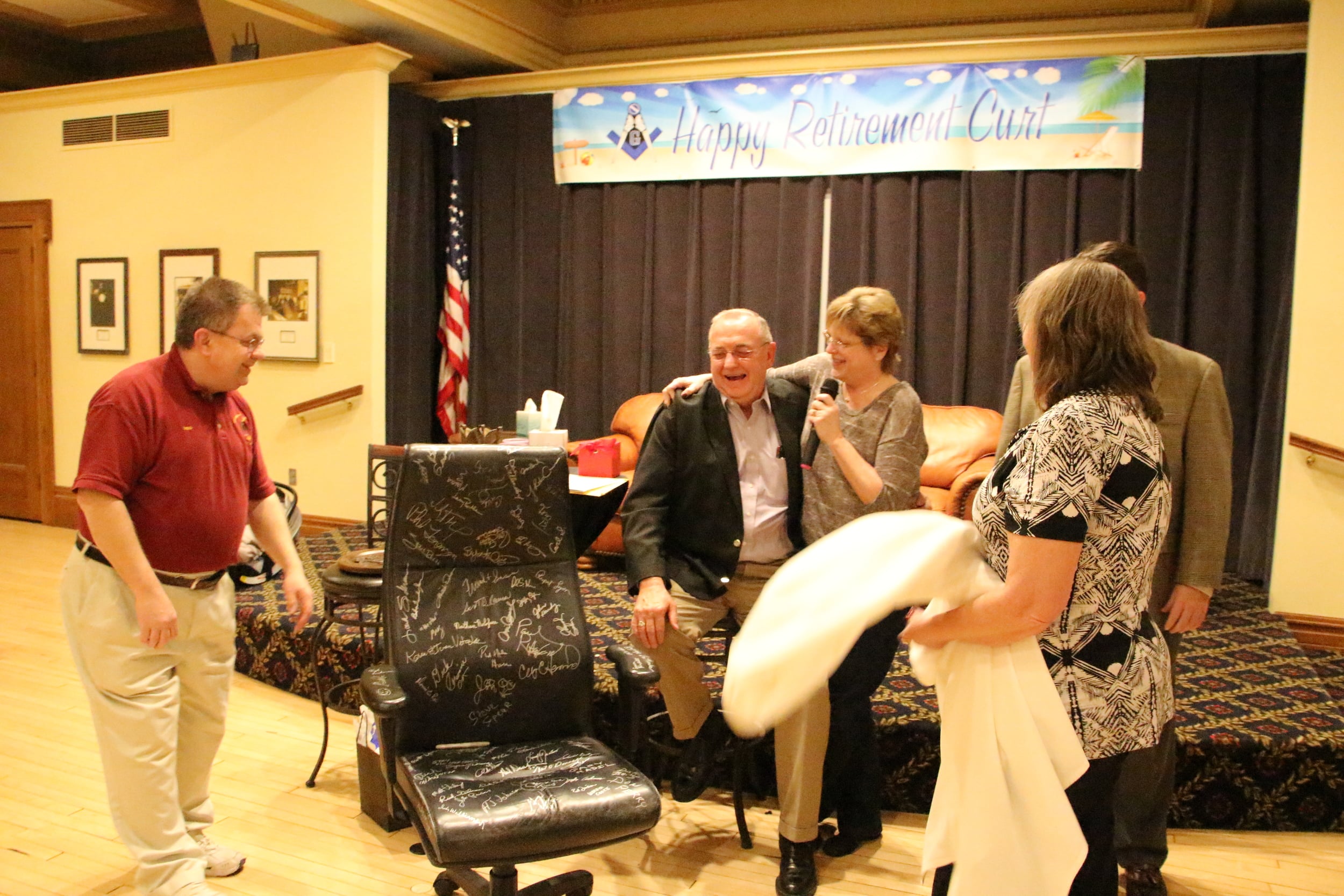 Presenting Curt with his office chair, signed by Masons