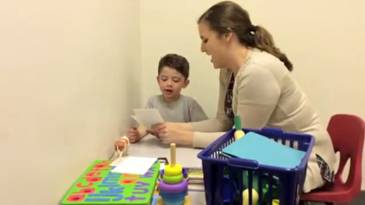 Miss Leslie working with Mason at the UNMC Munroe-Meyer Institute.