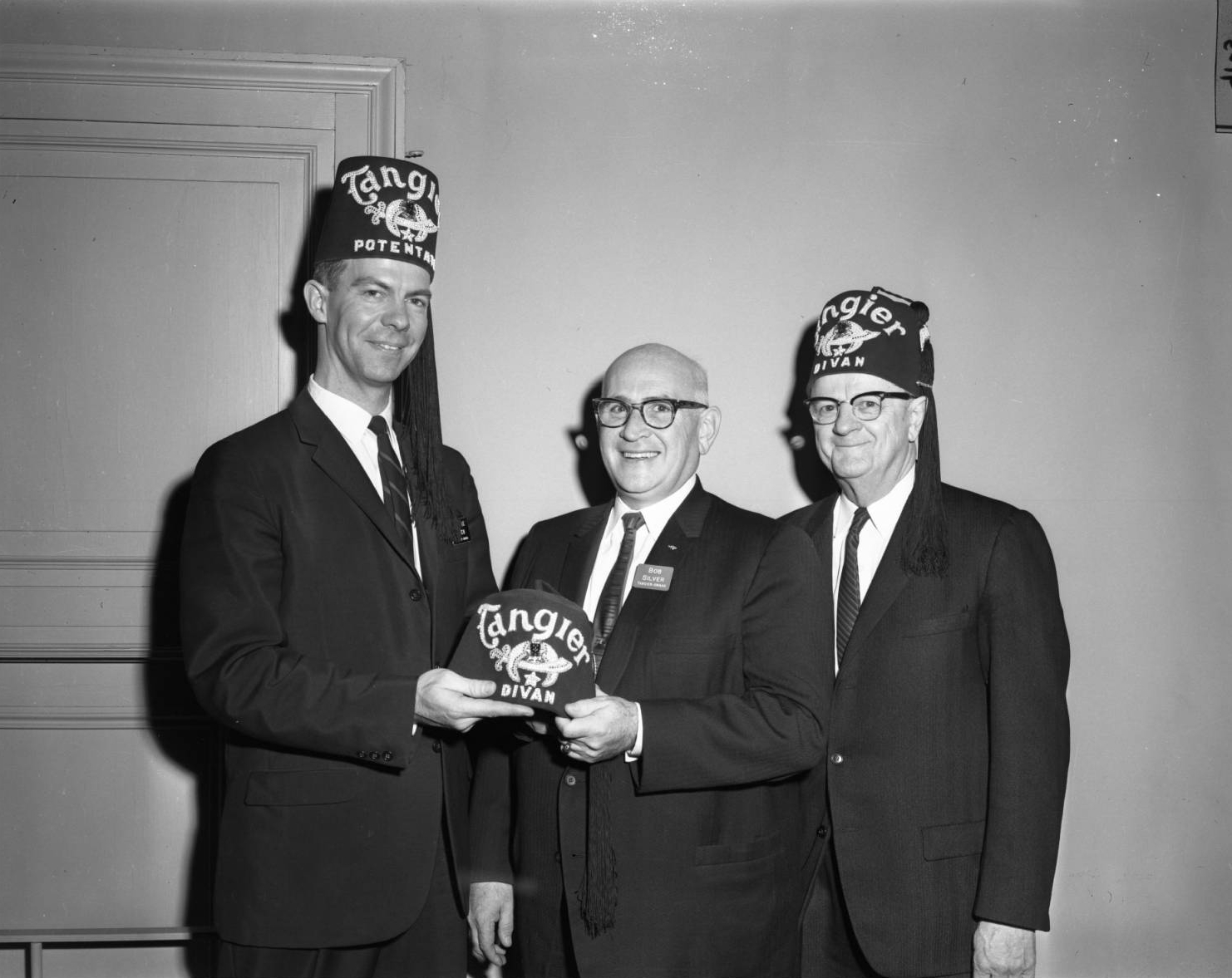 January 11 1963 OWH Potentate F. Jerome Given handing a Divan hat to Bob Silver while Walter Korisko watches..jpg