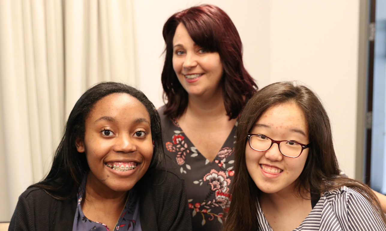 Adviser Shanon Woolf smiles with staff members of the McIntosh Trail.