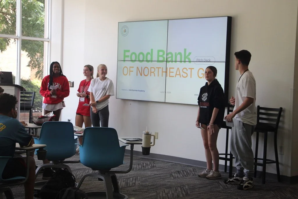 Five students present with the words Food Bank of Northeast GA on a screen behind them