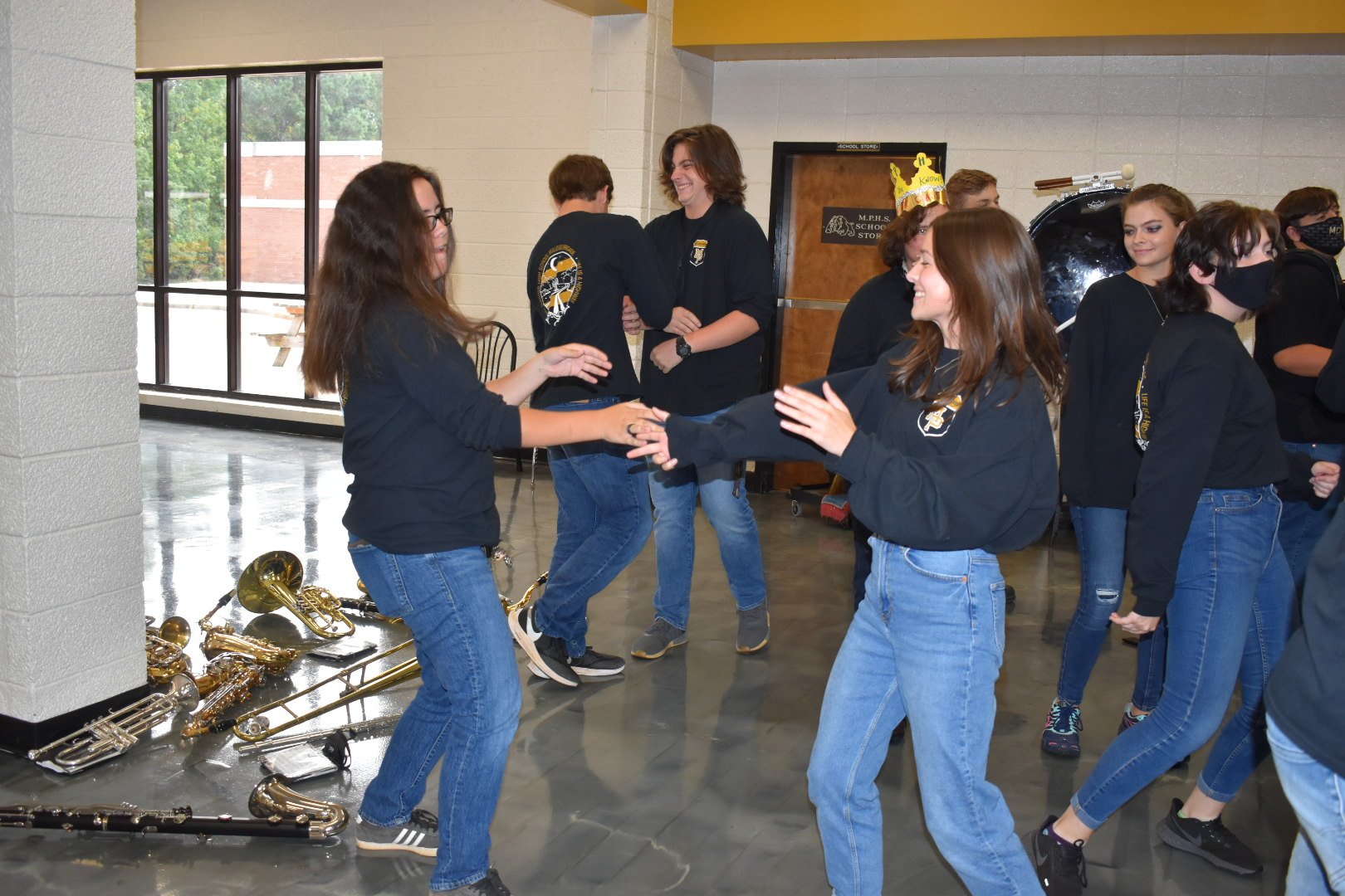  Senior band members, Marissa Hollis and Heather Tillman, do their special handshake as the cheerleaders and auxiliary team hype up the rest of the seniors before the big Homecoming Pep Rally. 