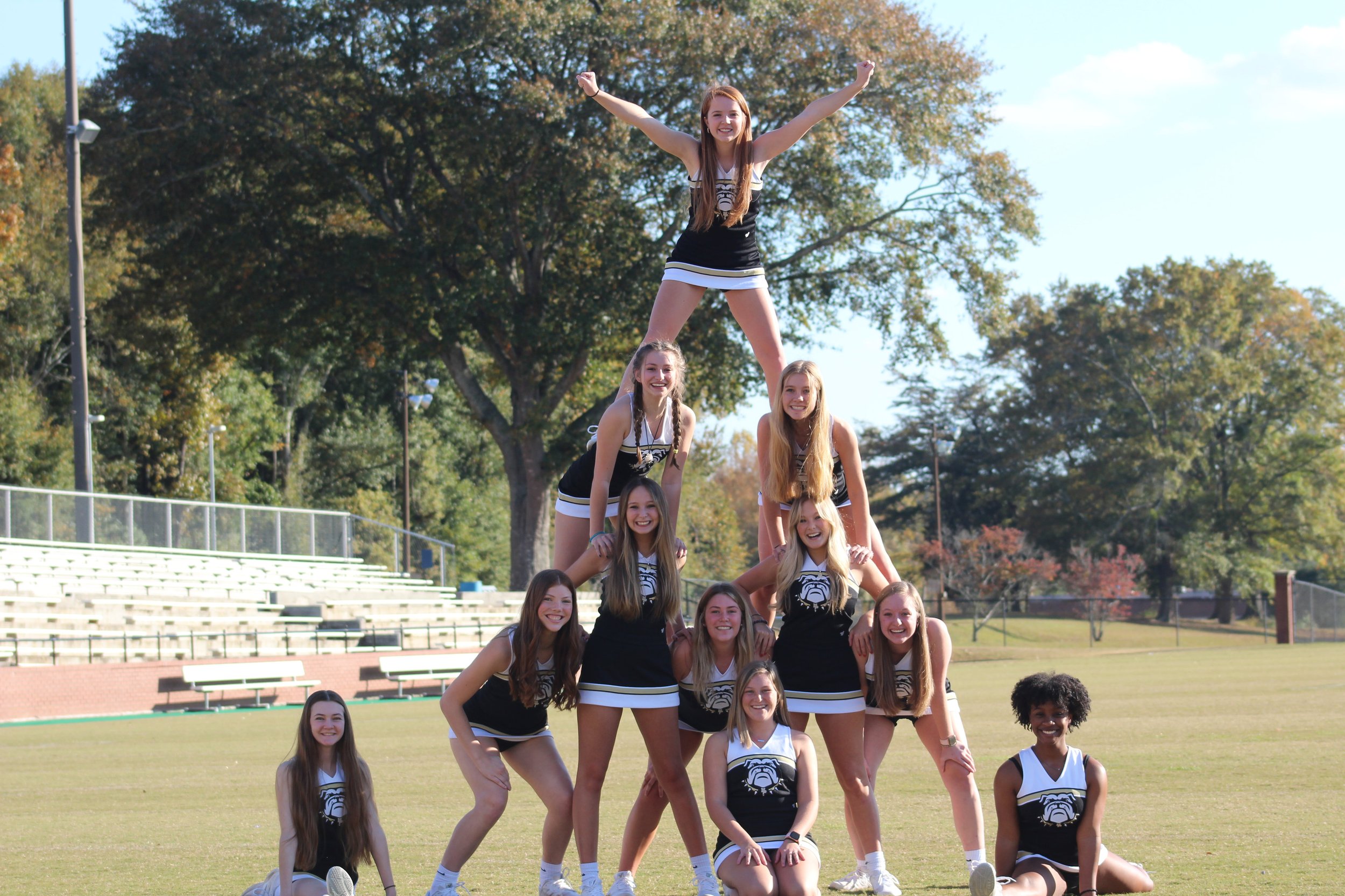  The JV Spirit cheerleaders help recreate an old cheerleading photo found in the 1970 edition of the Empescope. 