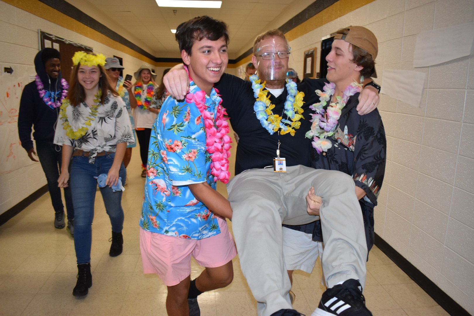  Students from Mr. Bernard’s Algebra 2 class, Jackson Campbell (11) and Landon Trice (11), carry him off during spirit week. 