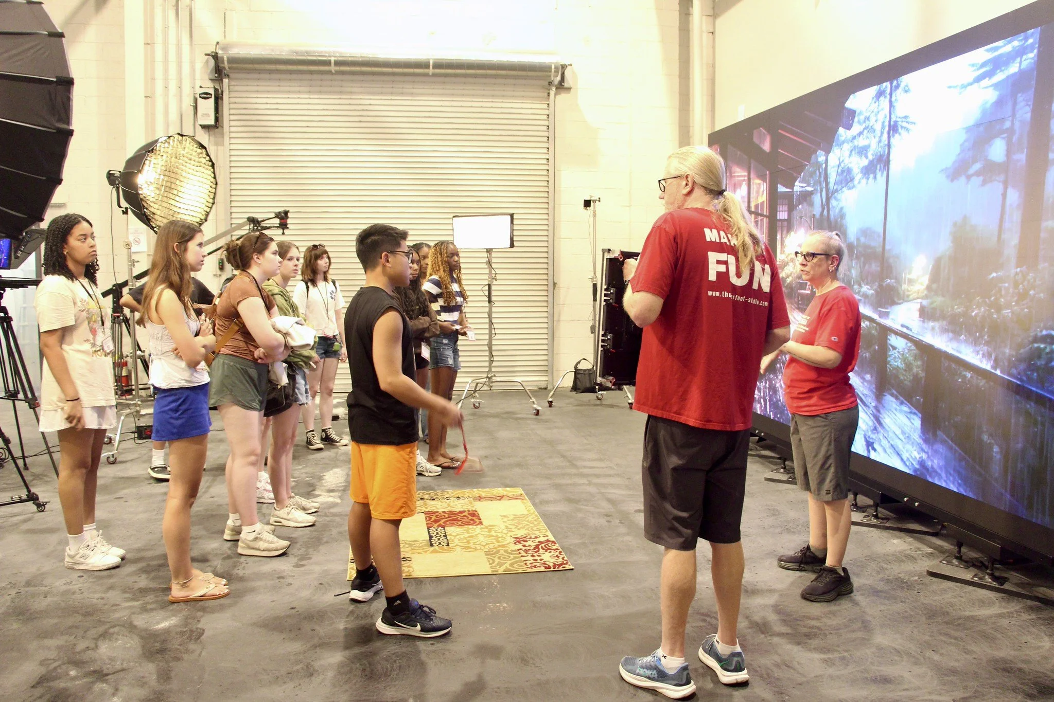 Students from the EMST summer academy visit a large digital videography studio to learn about lighting.