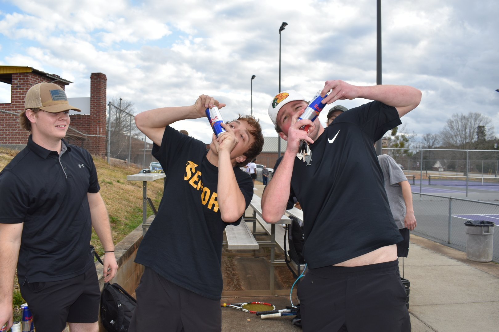  Members of the tennis team, Jackson Campbell (11) and Shawn Johnson (12), shotgun a Red Bull energy drink together before every match. 