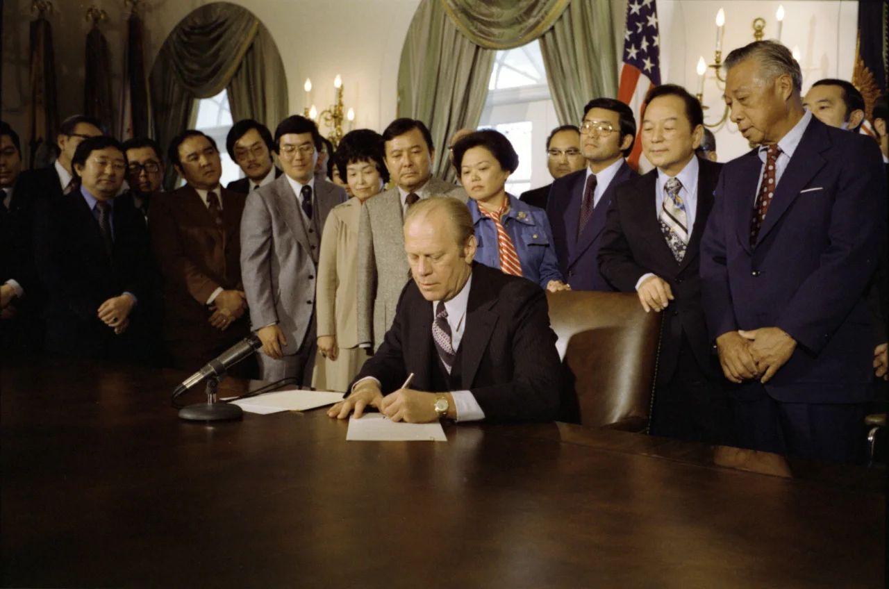 Gerald Ford signs Executive Order 4417. Photo from the White House archives.