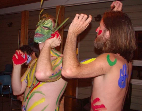 Men dancing in masks and body paint