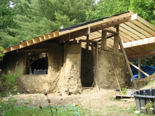 Mud structure with unfinished wooden roof