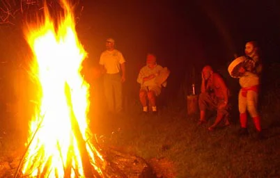 Men in circle around bonfire
